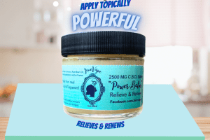 a green label jar with the words Power Balm. The words Relieves and Renews. With the Janevape logo