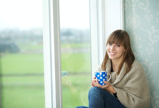 Young Woman Smiling with Tea Cup